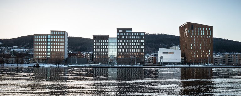 SporX office building is located by the river in Drammen, Norway.